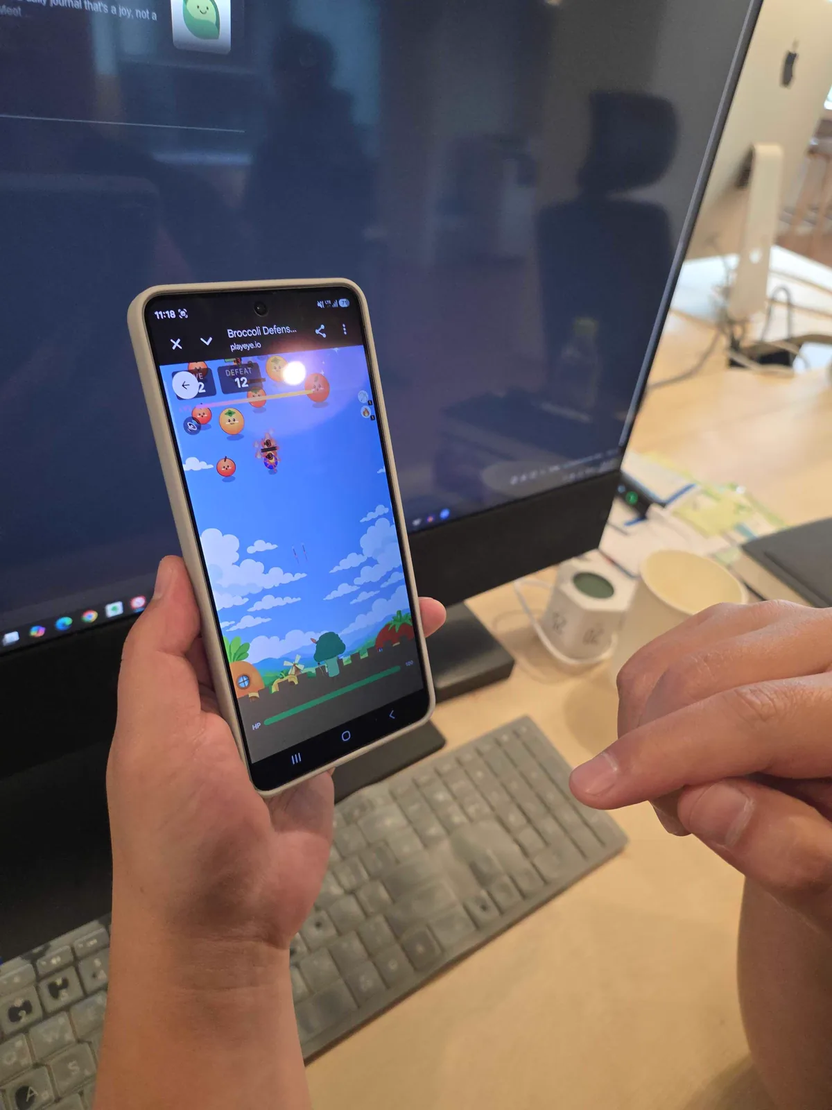 Broccoli Defense running on an Android phone with a bright blue sky behind the battle